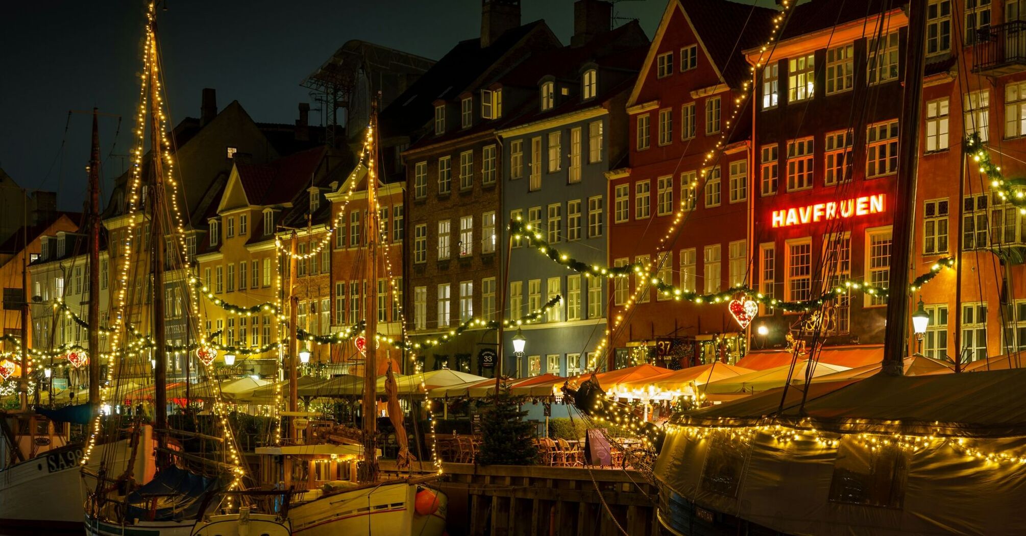 Copenhagen Nyhavn harbour lit up at night
