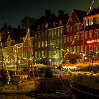 Copenhagen Nyhavn harbour lit up at night