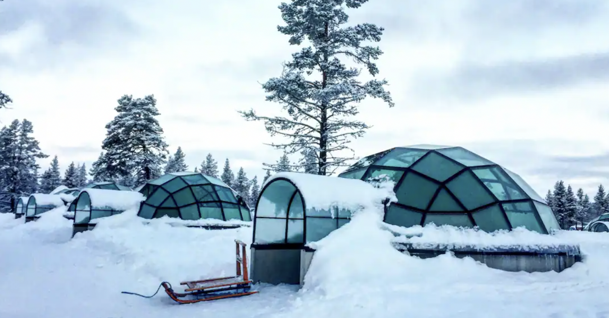 Glass igloos surrounded by snow in Finland