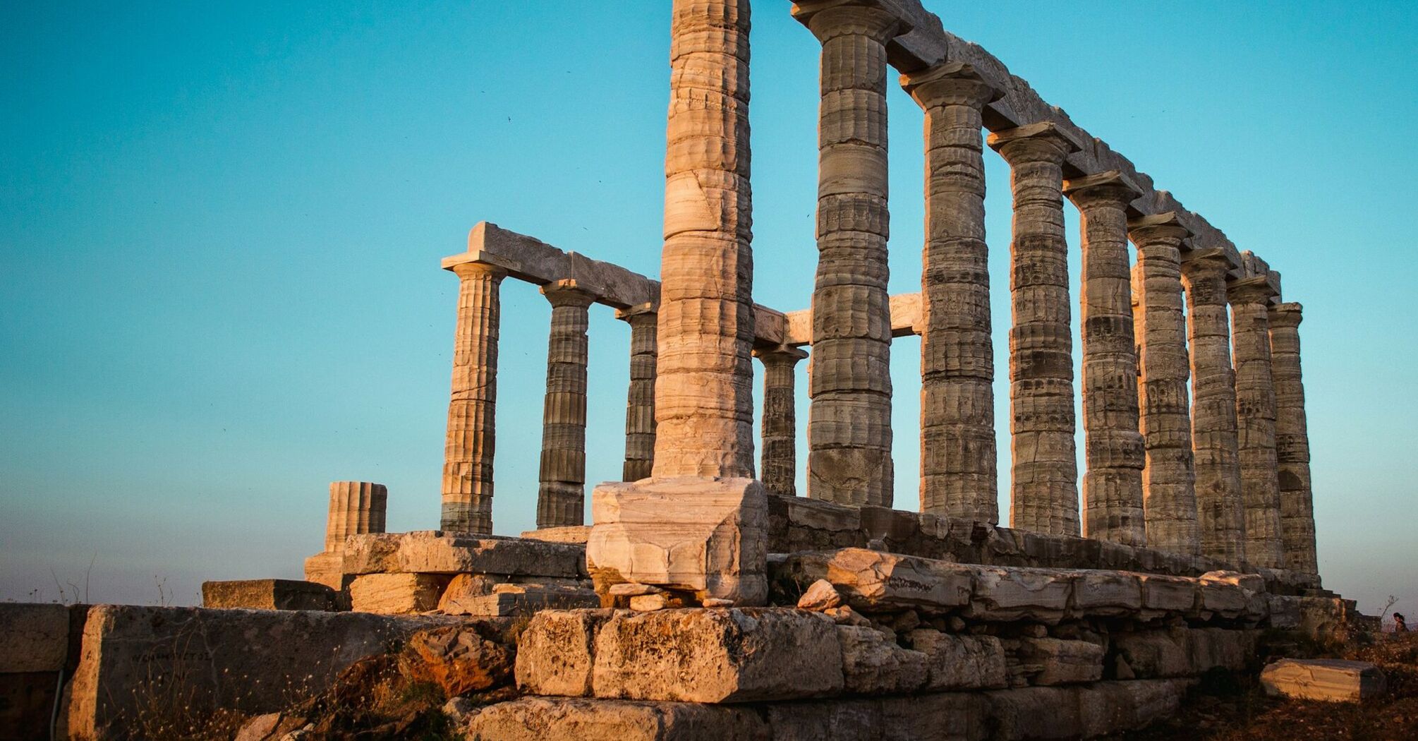 Ancient Greek temple ruins at sunset