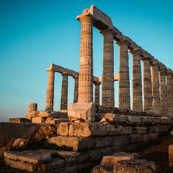 Ancient Greek temple ruins at sunset