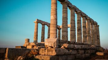 Ancient Greek temple ruins at sunset