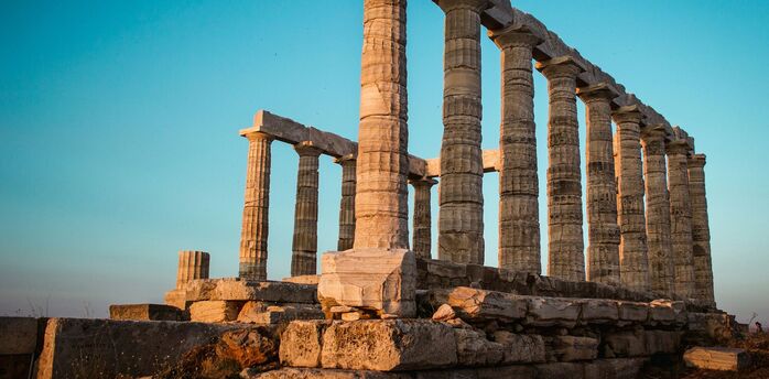 Ancient Greek temple ruins at sunset