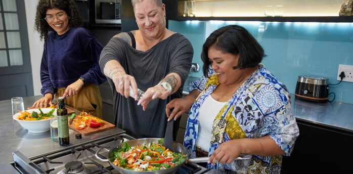 Travellers taking part in a cooking class