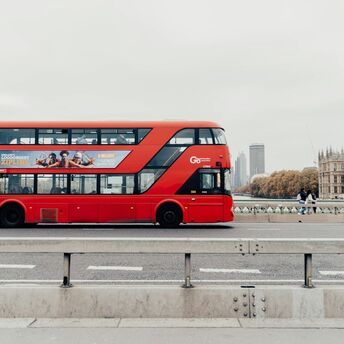 Red double-decker bus crossing Westminster Bridge in London