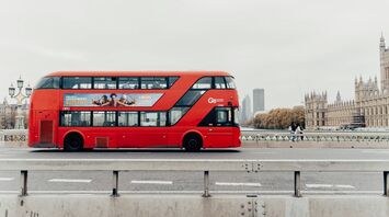 Red double-decker bus crossing Westminster Bridge in London