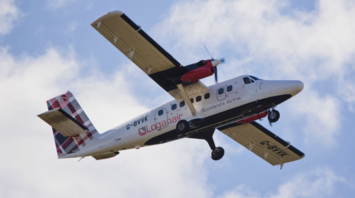 Loganair aircraft flying against a cloudy sky
