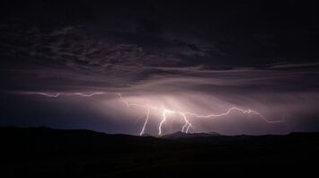 Lightning storm over a mountain landscape