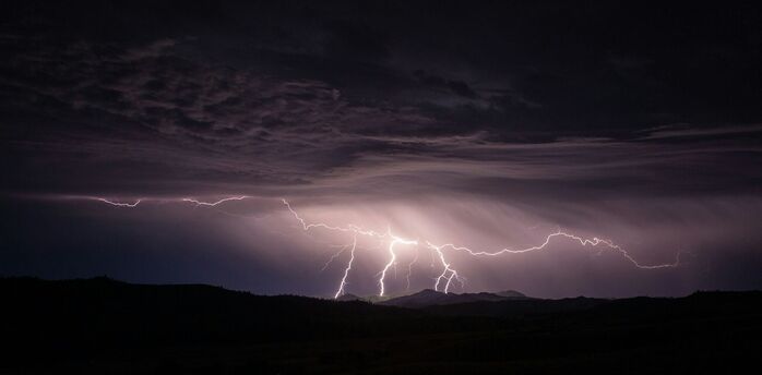 Lightning storm over a mountain landscape