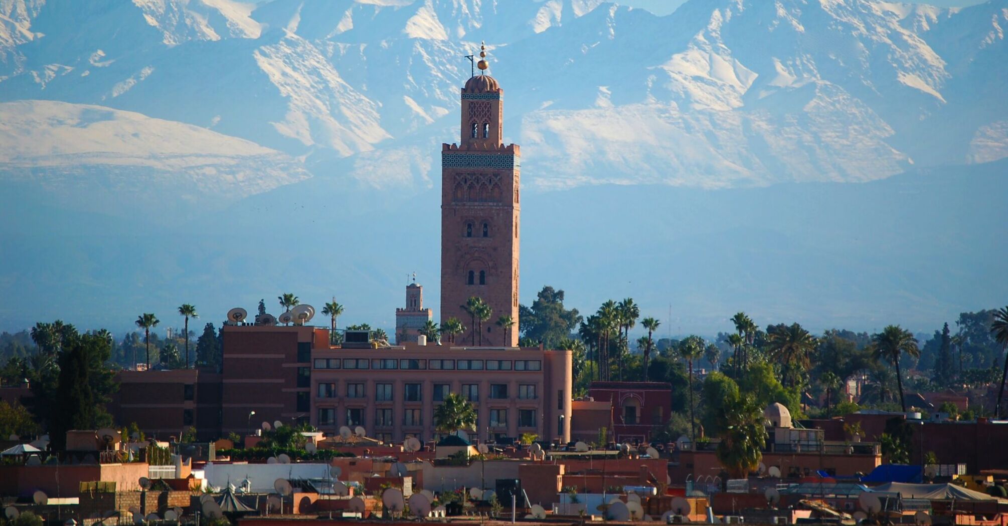 Koutoubia Mosque with the Atlas Mountains