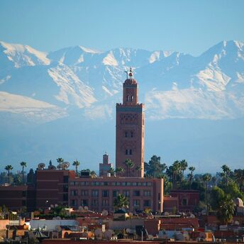 Koutoubia Mosque with the Atlas Mountains