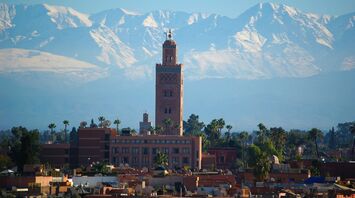 Koutoubia Mosque with the Atlas Mountains