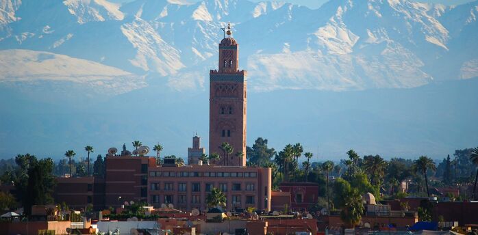 Koutoubia Mosque with the Atlas Mountains