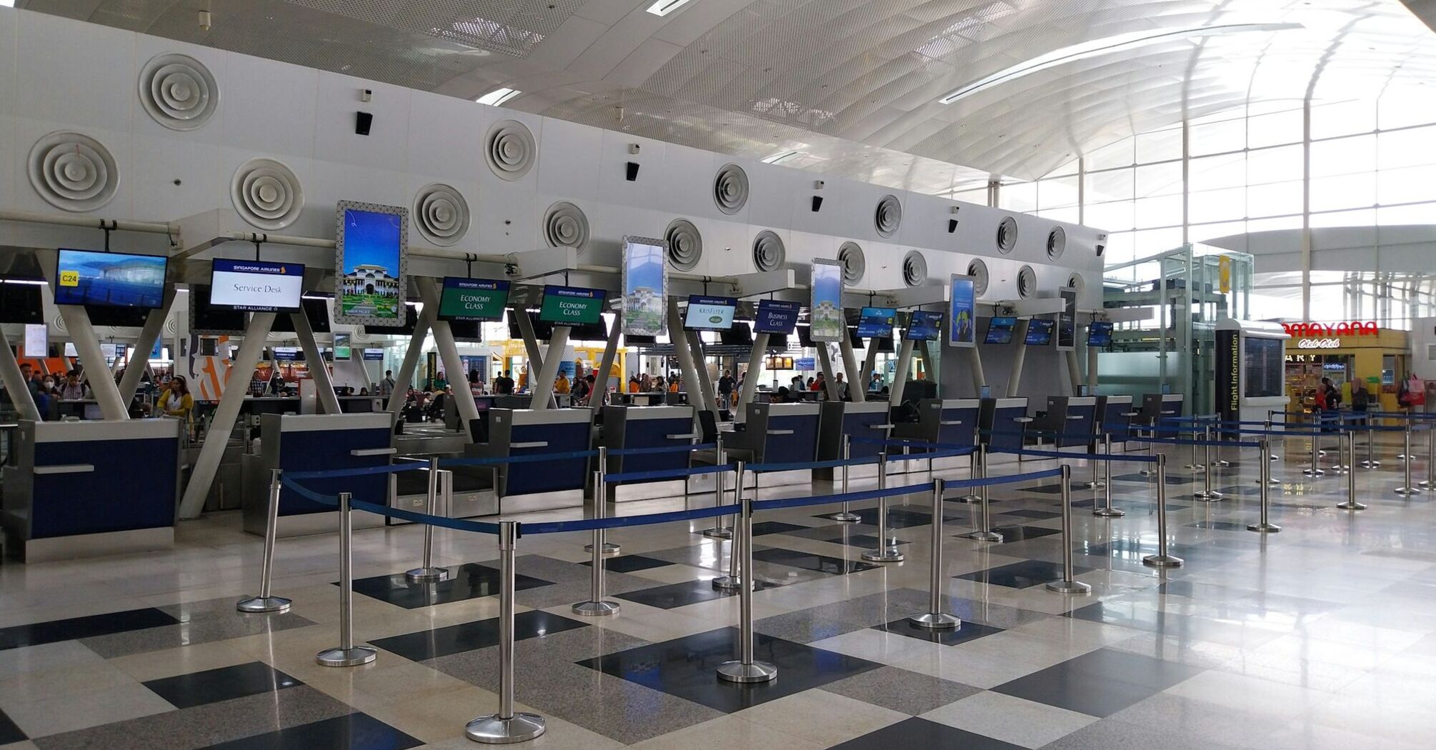 Airport check-in counters with queue barriers