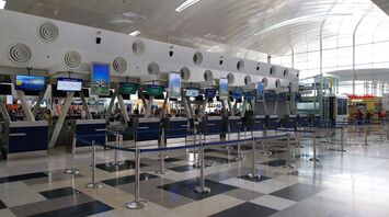 Airport check-in counters with queue barriers