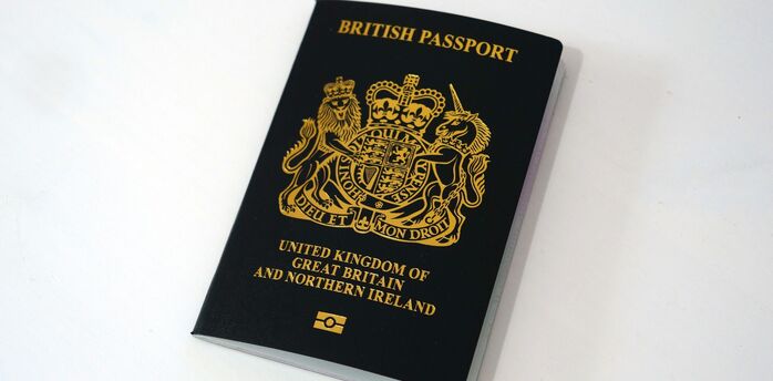Black British passport on white background