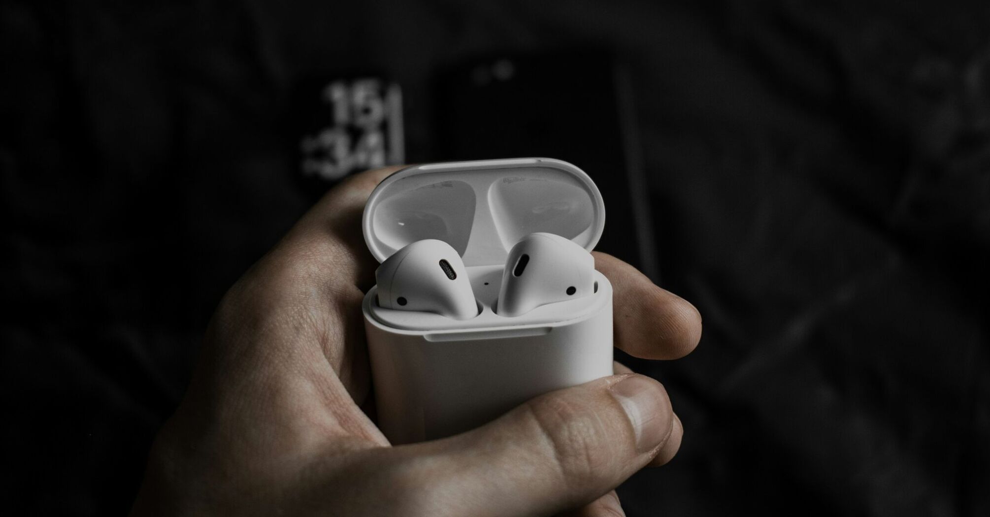 Wireless earbuds in an open charging case