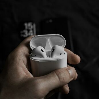 Wireless earbuds in an open charging case