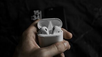 Wireless earbuds in an open charging case