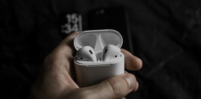 Wireless earbuds in an open charging case