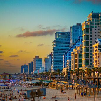 Tel Aviv beachfront and city skyline at sunset