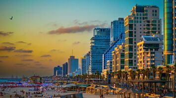Tel Aviv beachfront and city skyline at sunset