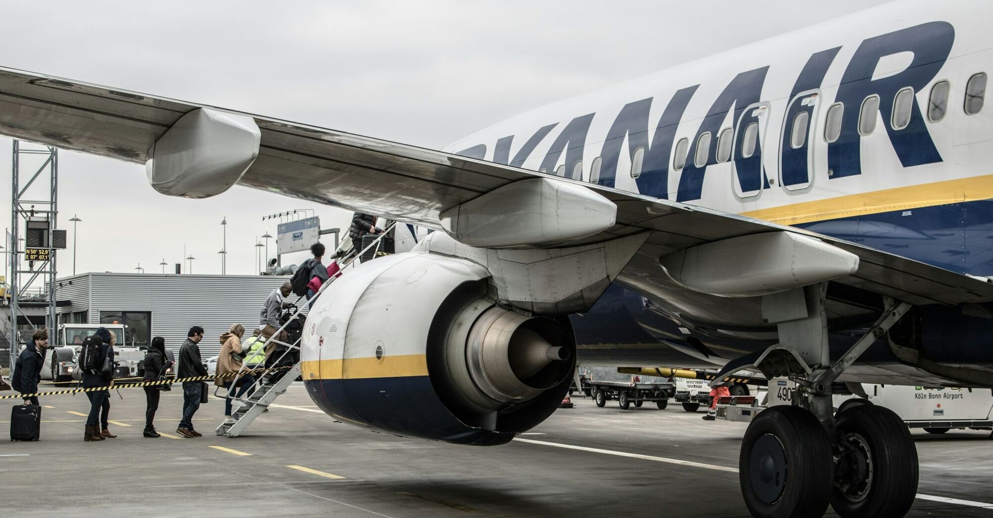 Passengers board a Ryanair aircraft on the apron