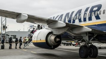 Passengers board a Ryanair aircraft on the apron