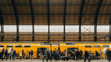 Rail passengers boarding a train at a station