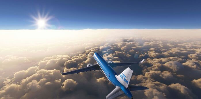 KLM aircraft flying above the clouds