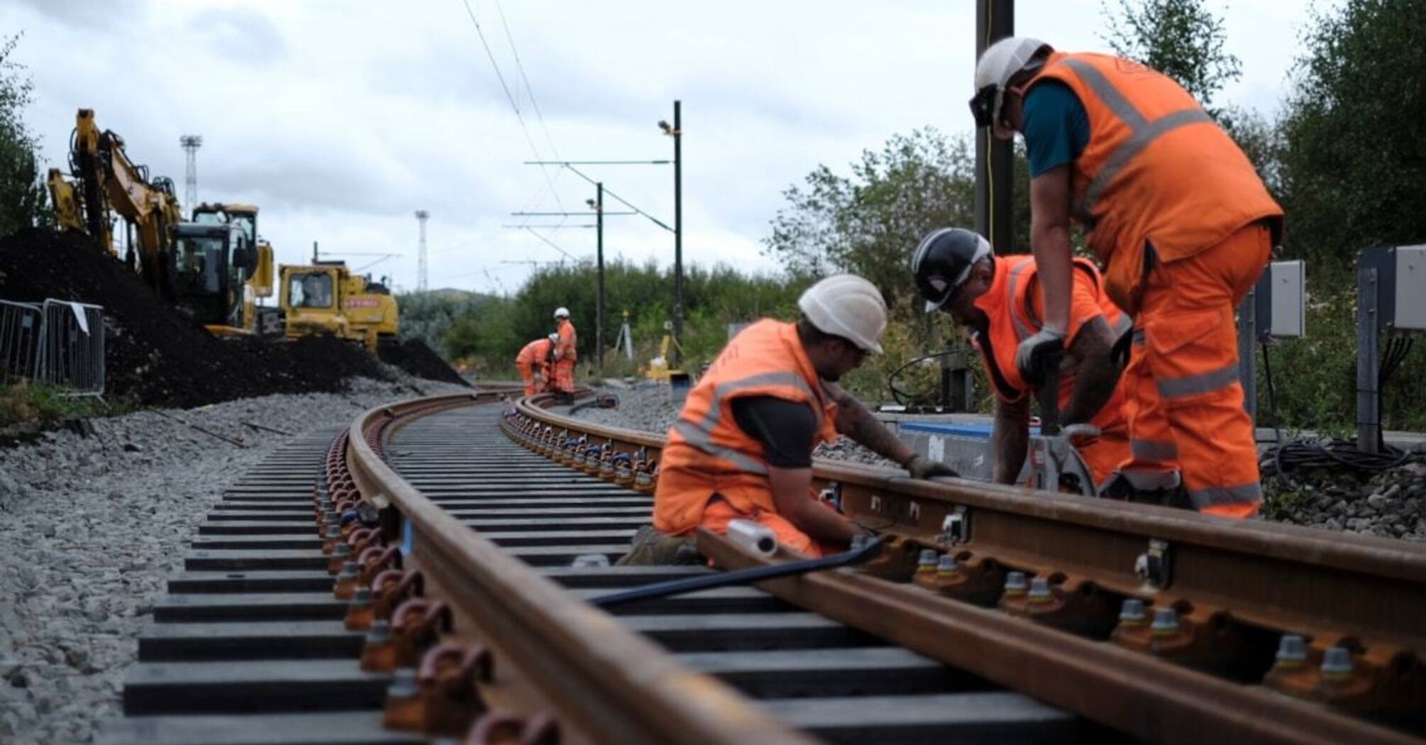 Rail workers renewing railway track