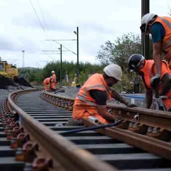 Rail workers renewing railway track