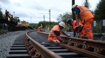 Rail workers renewing railway track