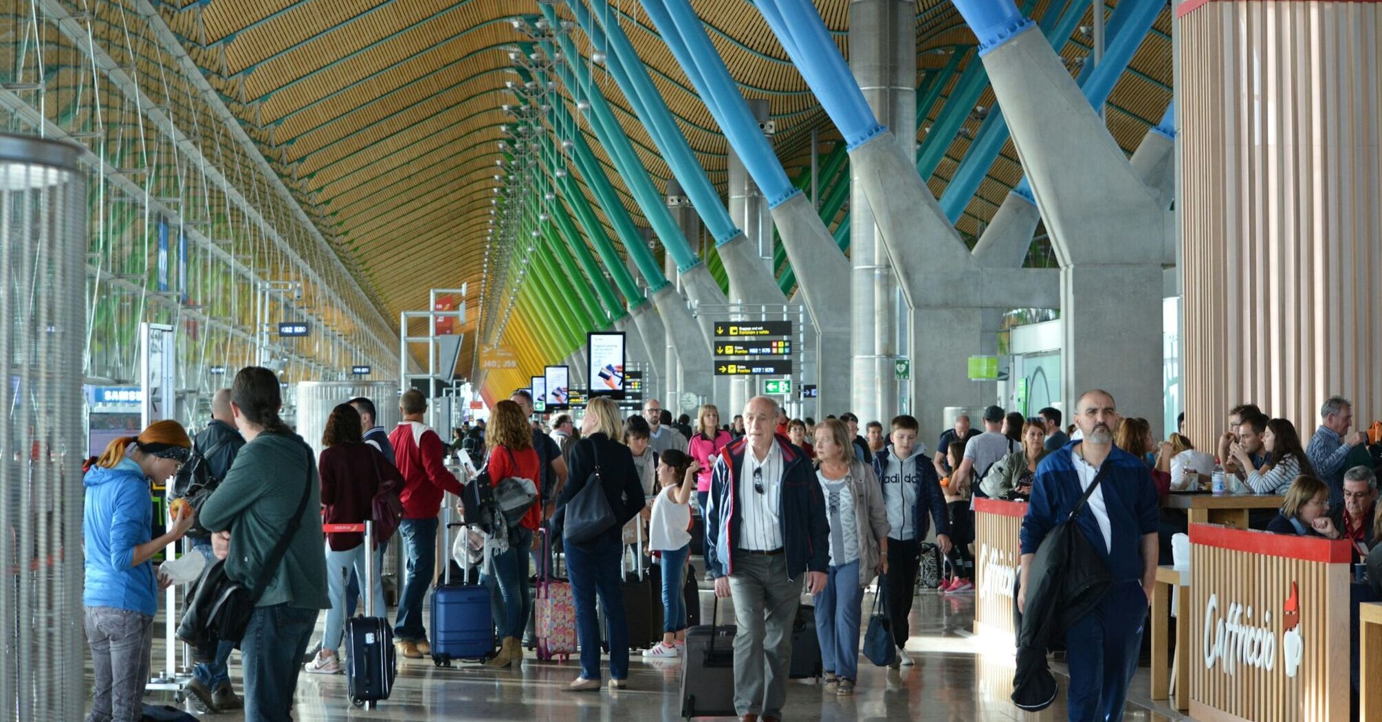 Passengers inside a busy Spanish airport terminal