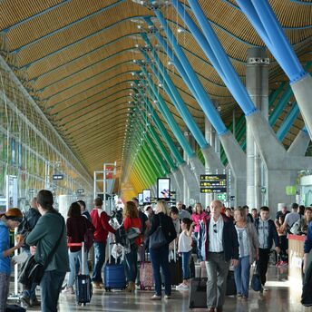 Passengers inside a busy Spanish airport terminal