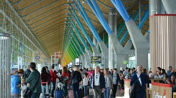 Passengers inside a busy Spanish airport terminal