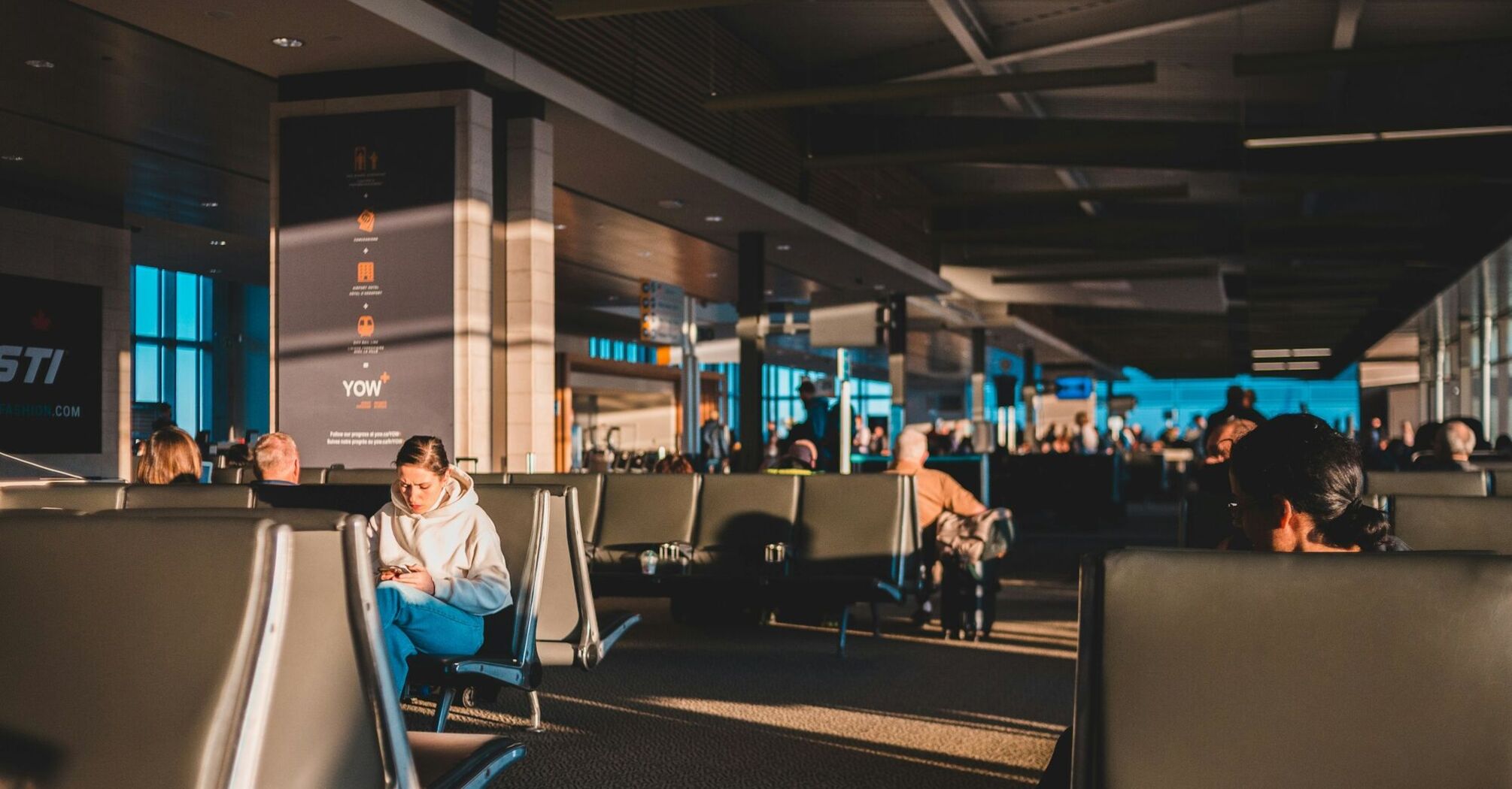 Passengers waiting inside an airport terminal