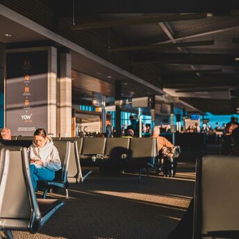Passengers waiting inside an airport terminal