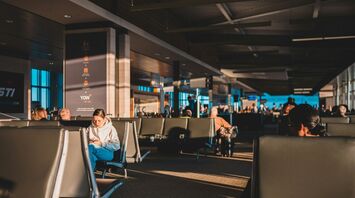 Passengers waiting inside an airport terminal