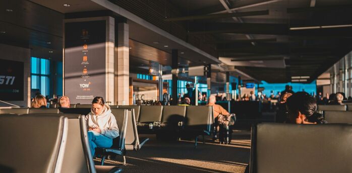 Passengers waiting inside an airport terminal
