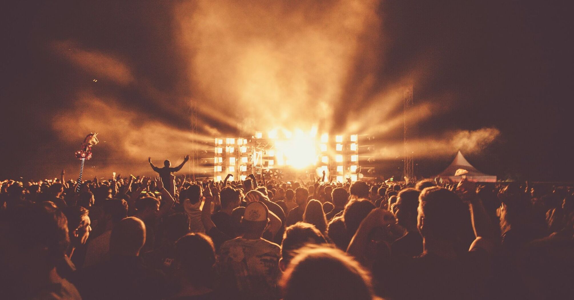 Crowd watching an outdoor concert at night