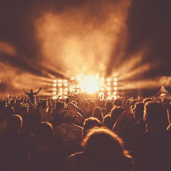 Crowd watching an outdoor concert at night
