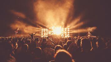 Crowd watching an outdoor concert at night