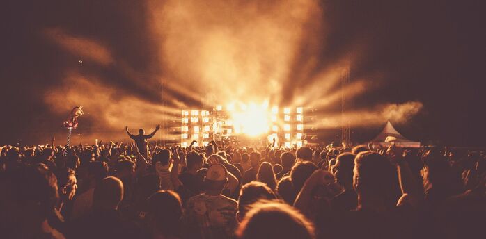 Crowd watching an outdoor concert at night