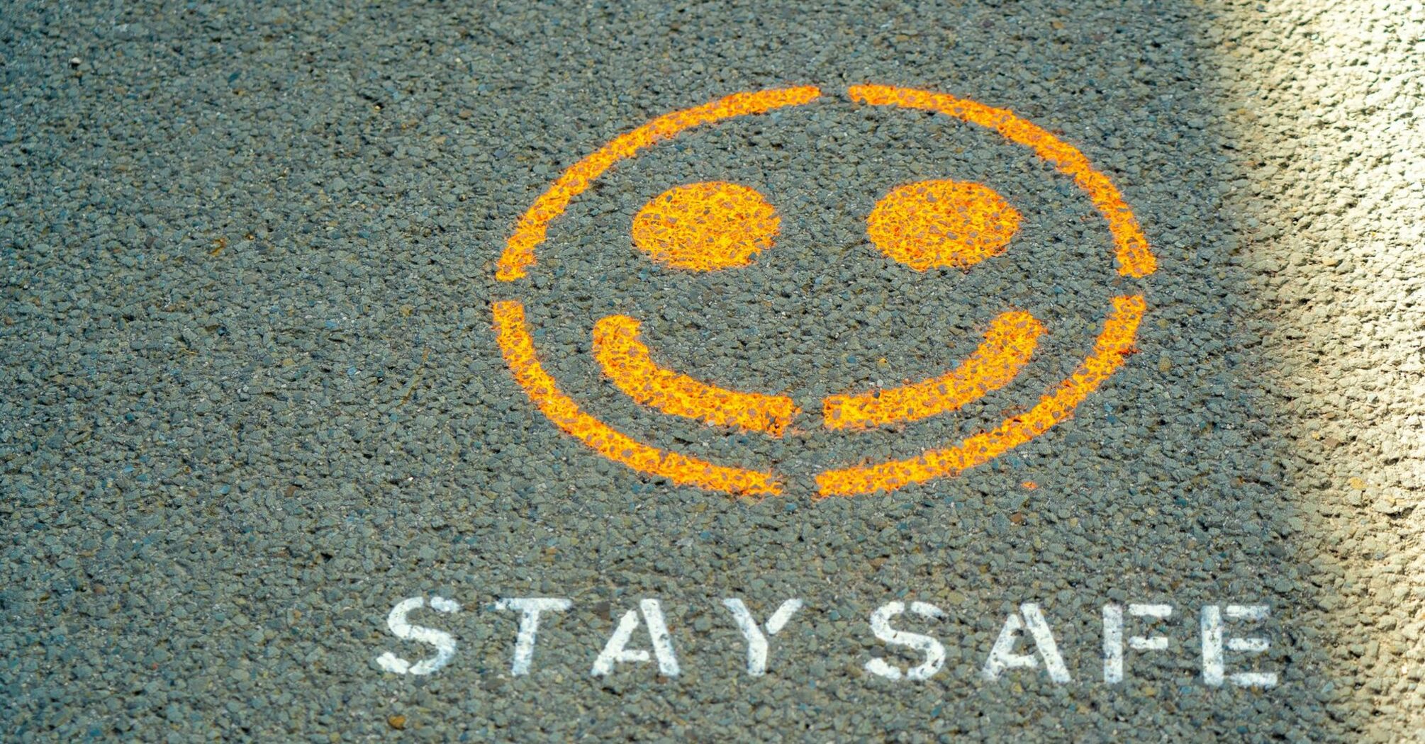 Stay safe message painted on pavement
