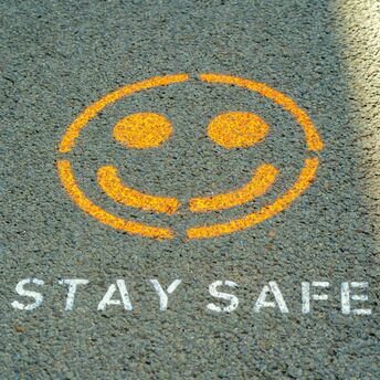 Stay safe message painted on pavement