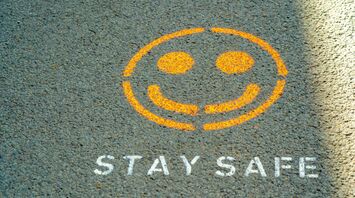 Stay safe message painted on pavement