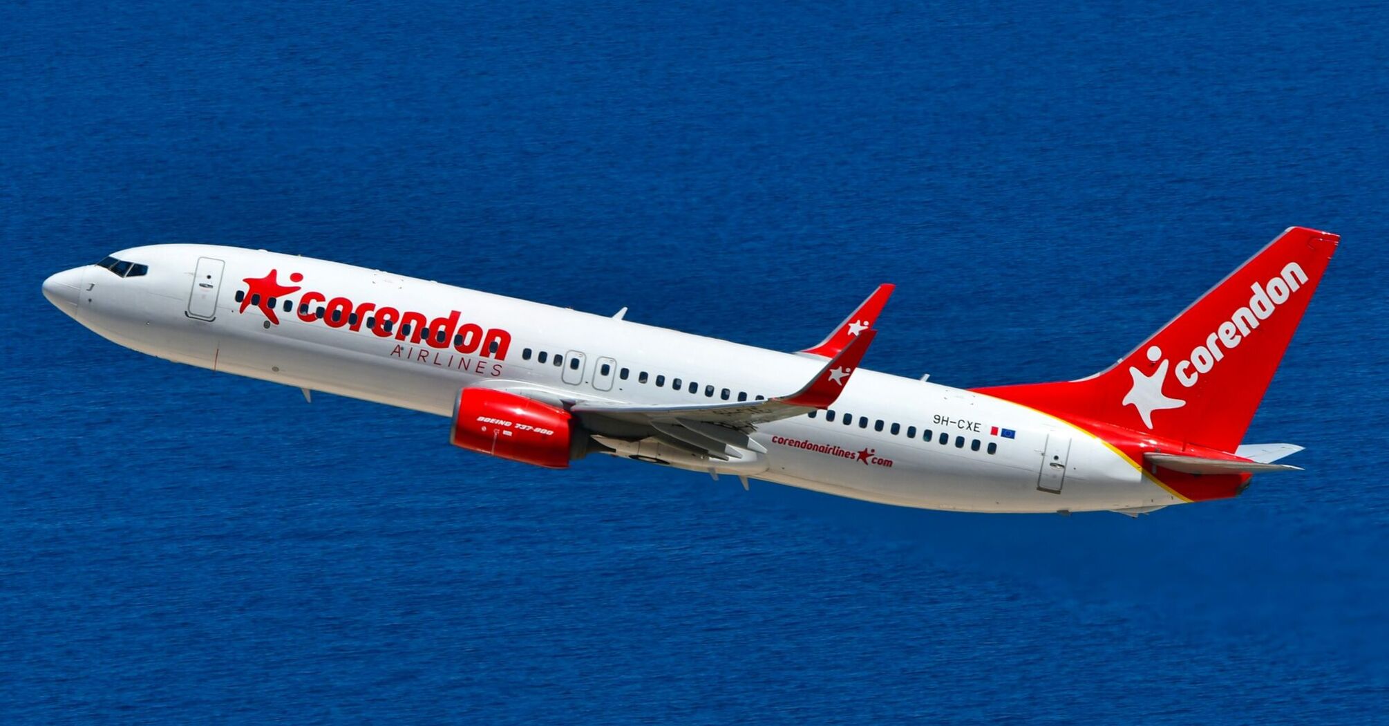 Corendon Airlines aircraft flying over the sea