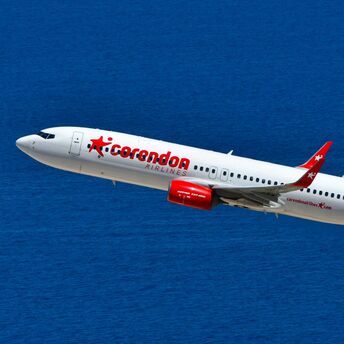 Corendon Airlines aircraft flying over the sea