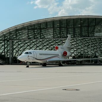 Aircraft parked outside an airport hangar